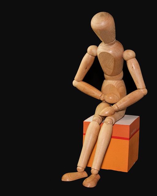 wooden figure holding stomach